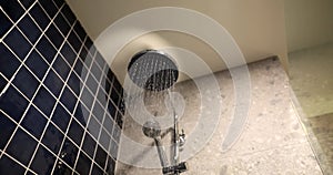 Jets of water flow from round shower head