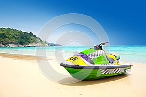 Jetski parked on a beach against blue sky photo