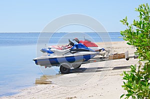 Jetskis on a trailer being launched into water