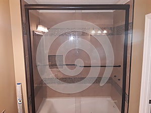 Jetted tub with glass door tile photo