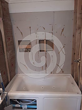 Jetted tub installed waiting on tile photo