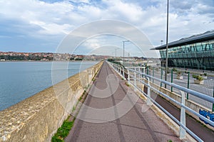 Jetty with 1 km of pedestrian access to the lighthouse with surrounding urban landscape. Getxo-Basque Country-Spain.