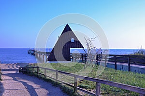 Jetty into the Baltic Sea, with a conspicuous building in the foreground