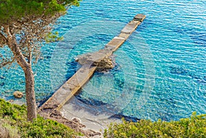 Jetty at beach with beautiful blue sea water