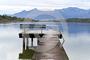 Jetty with a bench in a lake of Baviera photo