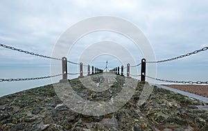 Jetty on the coastline in Hove, Sussex, UK. Photographed in a cold winter`s day