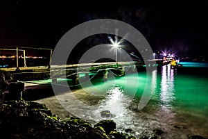 Jetty and Green Water at Night