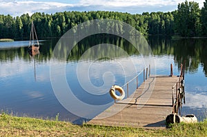 A jetty by an idyllic forest lake in Estonia