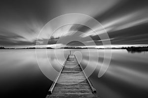 Jetty on a lake in black and white