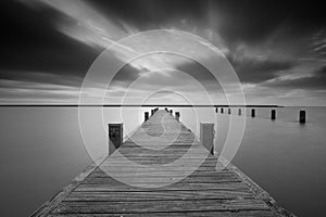 Jetty at lake Markermeer in black and white.