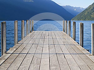 Jetty on Lake Roto-iti projecting into lake with mountain background photo