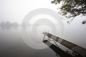 Jetty in the misty river Meuse