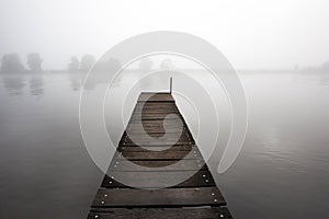 Jetty in the misty river Meuse