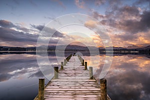 Jetty over Windermere lake with early morning sunlight