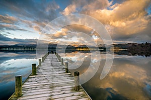 Jetty over Windermere lake with stunning clouds