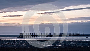 Jetty in the sea on a cloudy day in autumn