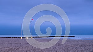 Jetty in the sea on a cloudy evening in autumn