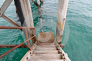 A jetty staircase leading down to the water at Port Noarlunga So