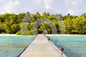 Jetty to a little tropical island in the turquoise indian ocean, maldives, way to a travel