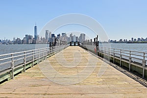 Jetty with a View of Manhattan Skyline from Liberty Island, NY photo