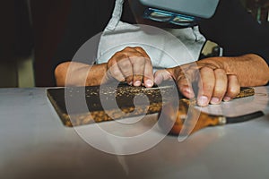 jeweler craftsman working on detailed manufacturing a ring wearing protective glasses and metal tool to carve the jewel