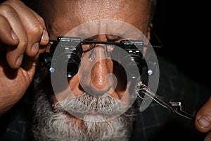 jeweler evaluating diamond ring in workshop, closeup view