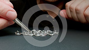 Jeweler examine diamonds on the table