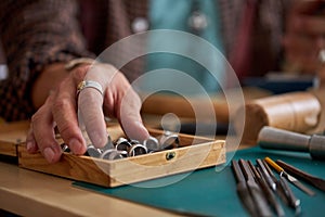 jeweler making craft jewelery with professional tools