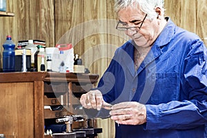 Jeweler measuring with a caliper gauge.