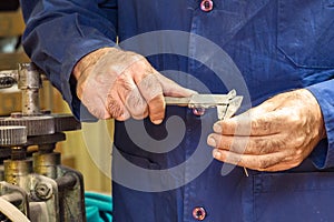 Jeweler measuring with a caliper gauge.