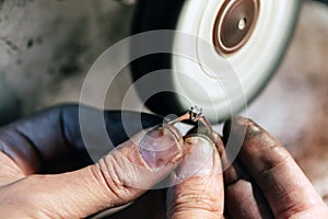 Jeweler polishing jewelry