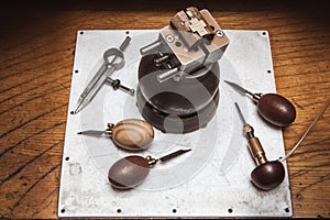 Jeweler`s workplase with tools and cross in bullseye vise photo
