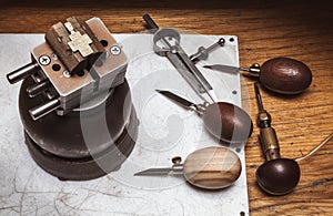Jeweler`s workplase with tools and cross in bullseye vise photo