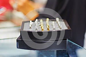 Jeweler stand with selection of wedding rings