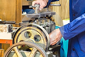 A jeweler using a Jewerly laminator machine.