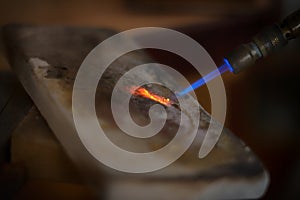 Jeweler welding a gold bracelet. Goldsmith jewelry. Craftsman jeweler working on jewelry. Goldsmith. Goldsmith workshop jewels and