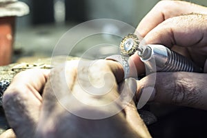 Jeweler weler using a copper wire brush with a flex shaft.