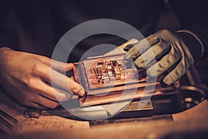 Jeweler at work in jewelery workshop