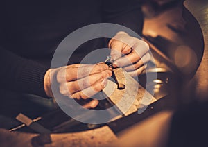 Jeweler at work in jewelery workshop