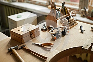 Jewelers workstation with wooden table and various tools