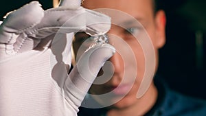 A jeweller checks a big diamond.