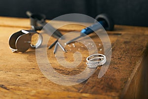 Jeweller, engraver at work on jewelry made of diamonds and gold