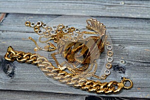 Jewellery or jewelry isolated on wooden background, decorative items worn for personal adornment, such as brooches, rings,