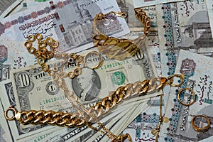 Jewellery or jewelry with USD American dollars and EGP LE Egyptian pounds cash money banknotes, brooches, rings, necklaces,
