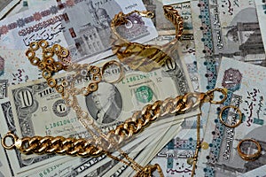 Jewellery or jewelry with USD American dollars and EGP LE Egyptian pounds cash money banknotes, brooches, rings, necklaces,