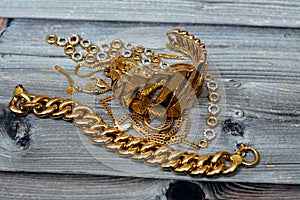 Jewellery or jewelry  on wooden background, decorative items worn for personal adornment, such as brooches, rings,