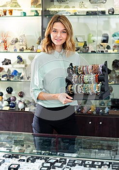 Jewellery shop assistant showing bracelets