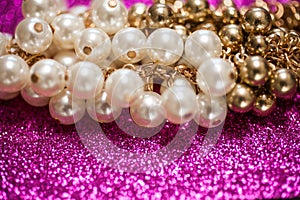 Jewelry background with white and golden pearls