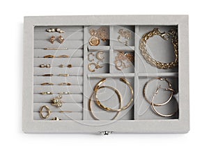 Jewelry box with many different golden accessories isolated on white, top view