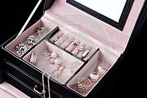 Jewelry box with white gold and silver rings, earrings and pendants with pearls. Collection of luxury jewelry.